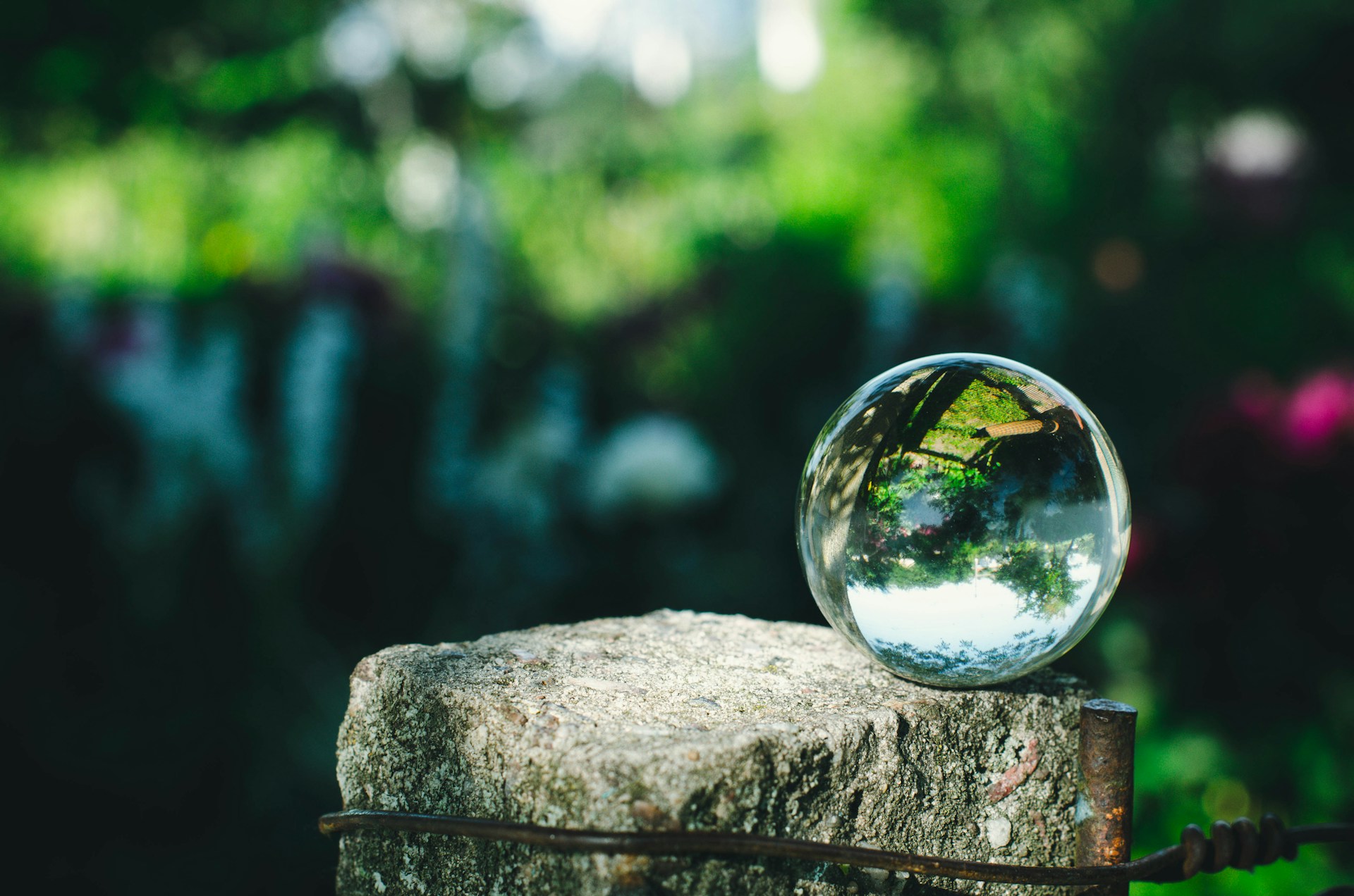 clear glass ball on gray rock