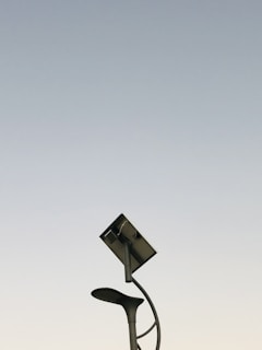 A high mast solar lighting system illuminating a busy street in the evening, showcasing sustainable urban energy.