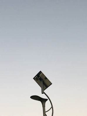 A modern solar lighting pole installed in a park.