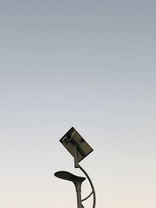 A modern solar lighting pole in a green park.