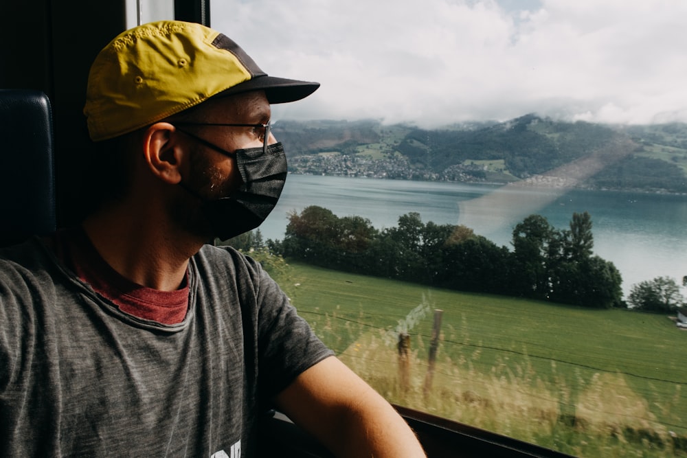 man in gray crew neck t-shirt wearing yellow cap