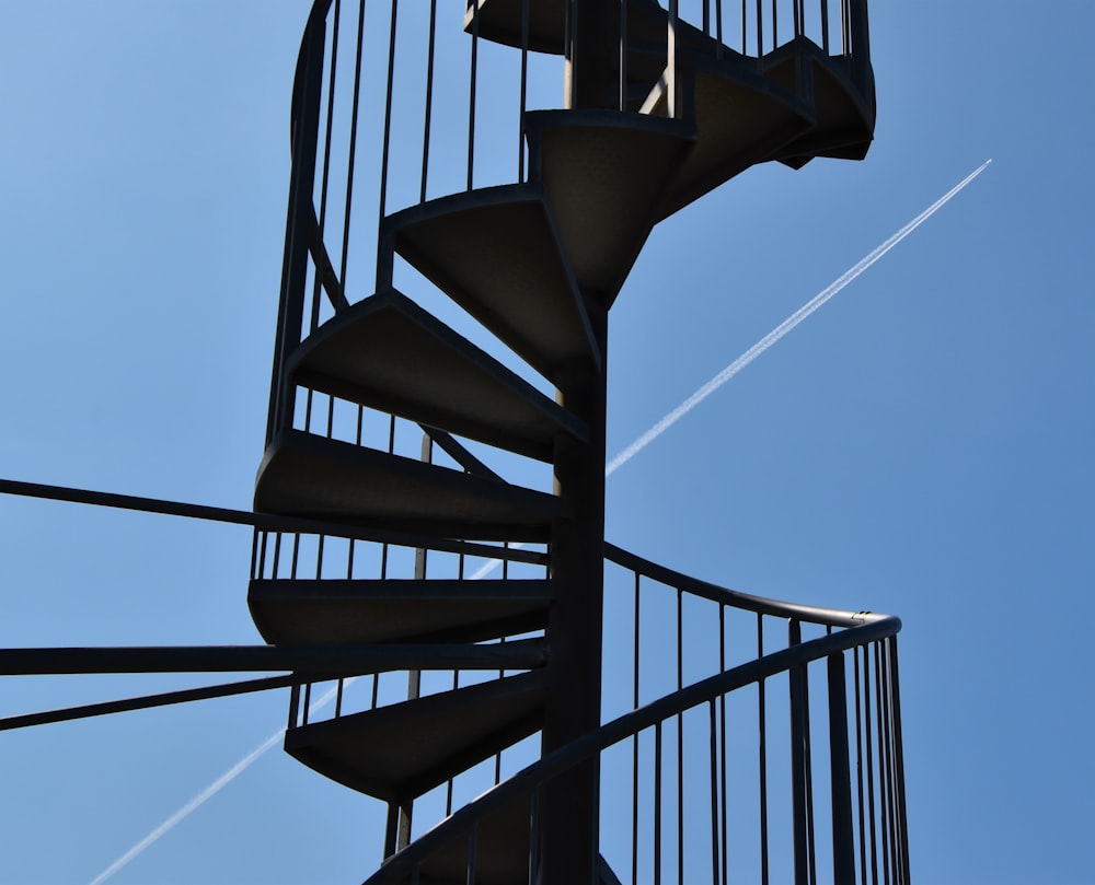 black spiral staircase under blue sky during daytime