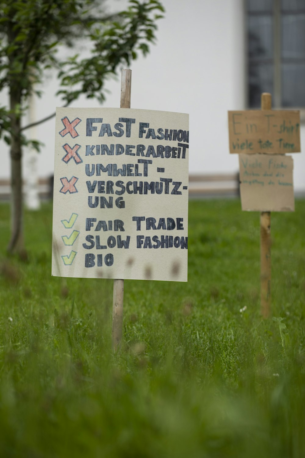 white wooden signage on green grass field