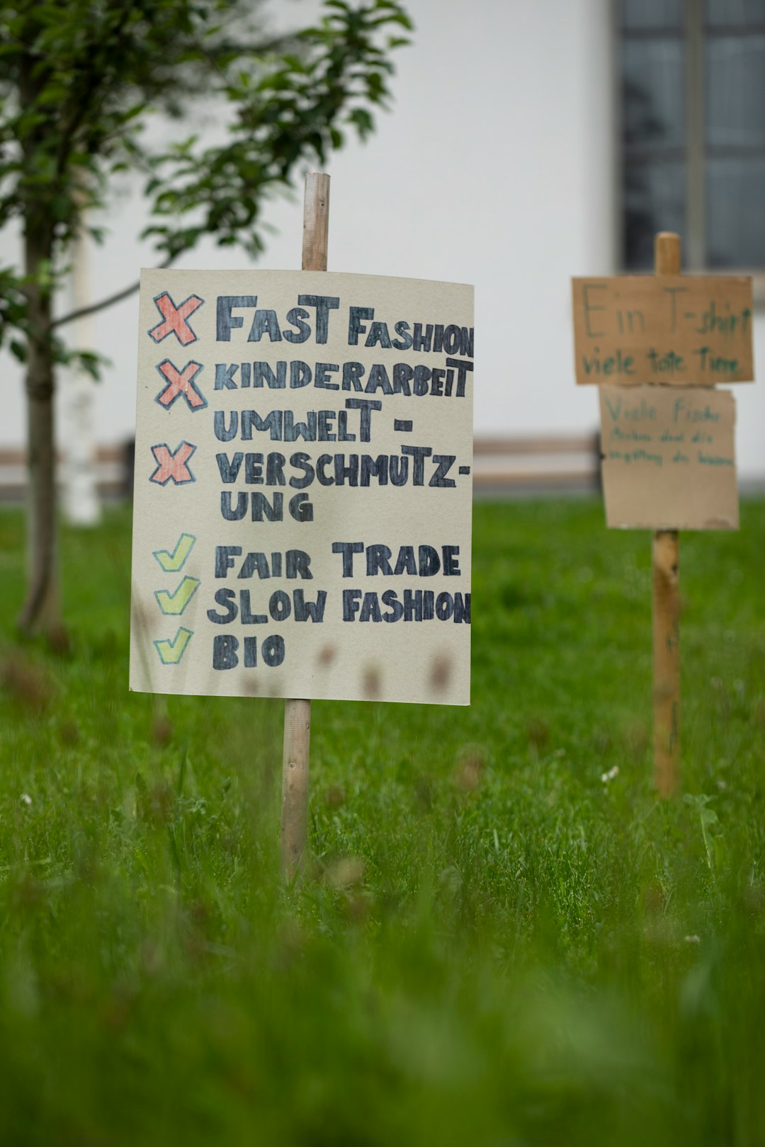 white wooden signage on green grass field