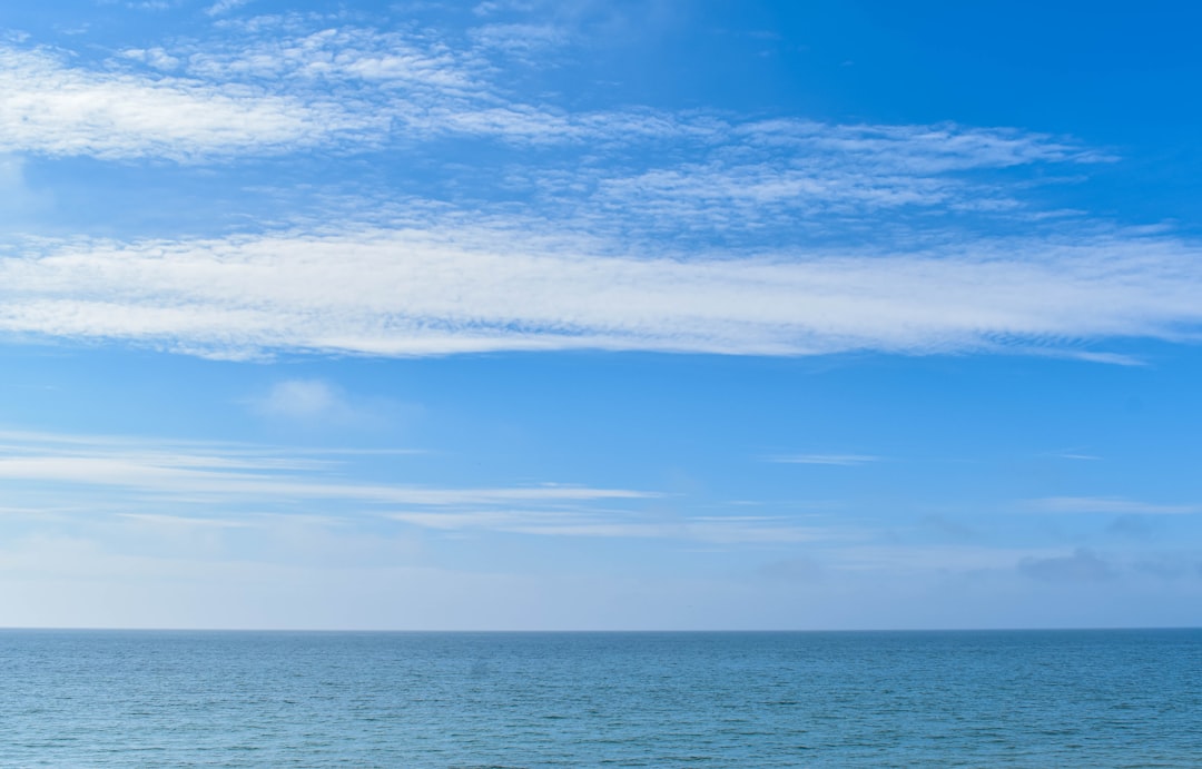 blue ocean under blue sky during daytime