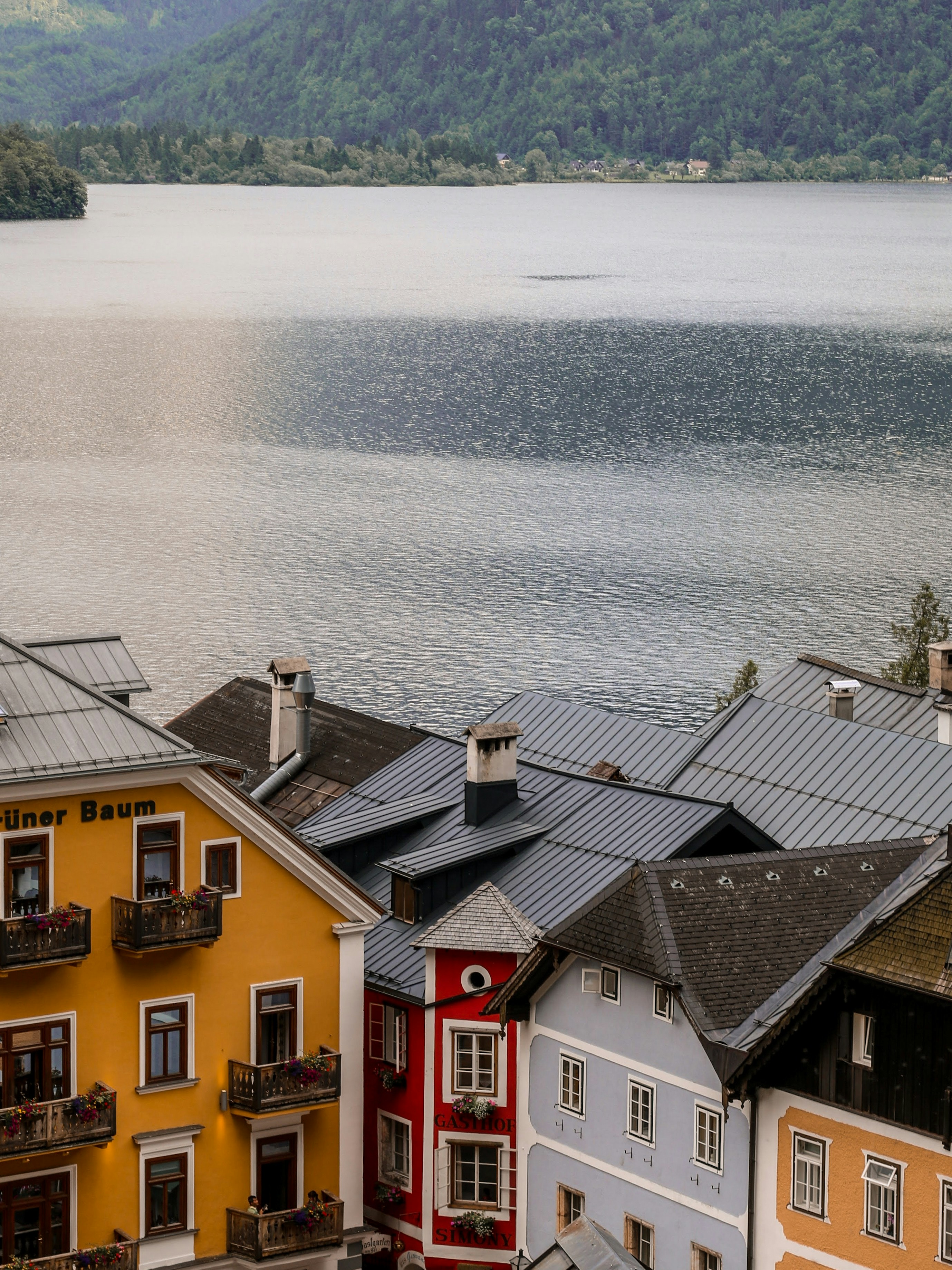 brown and red concrete houses beside body of water during daytime