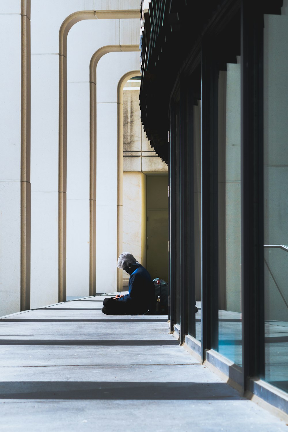 man in black jacket sitting on floor