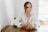 woman in white blazer sitting by the table
