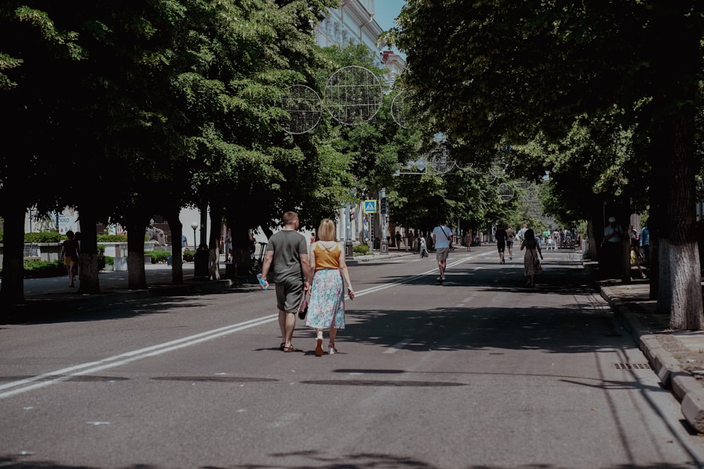 woman in white dress walking on sidewalk during daytime