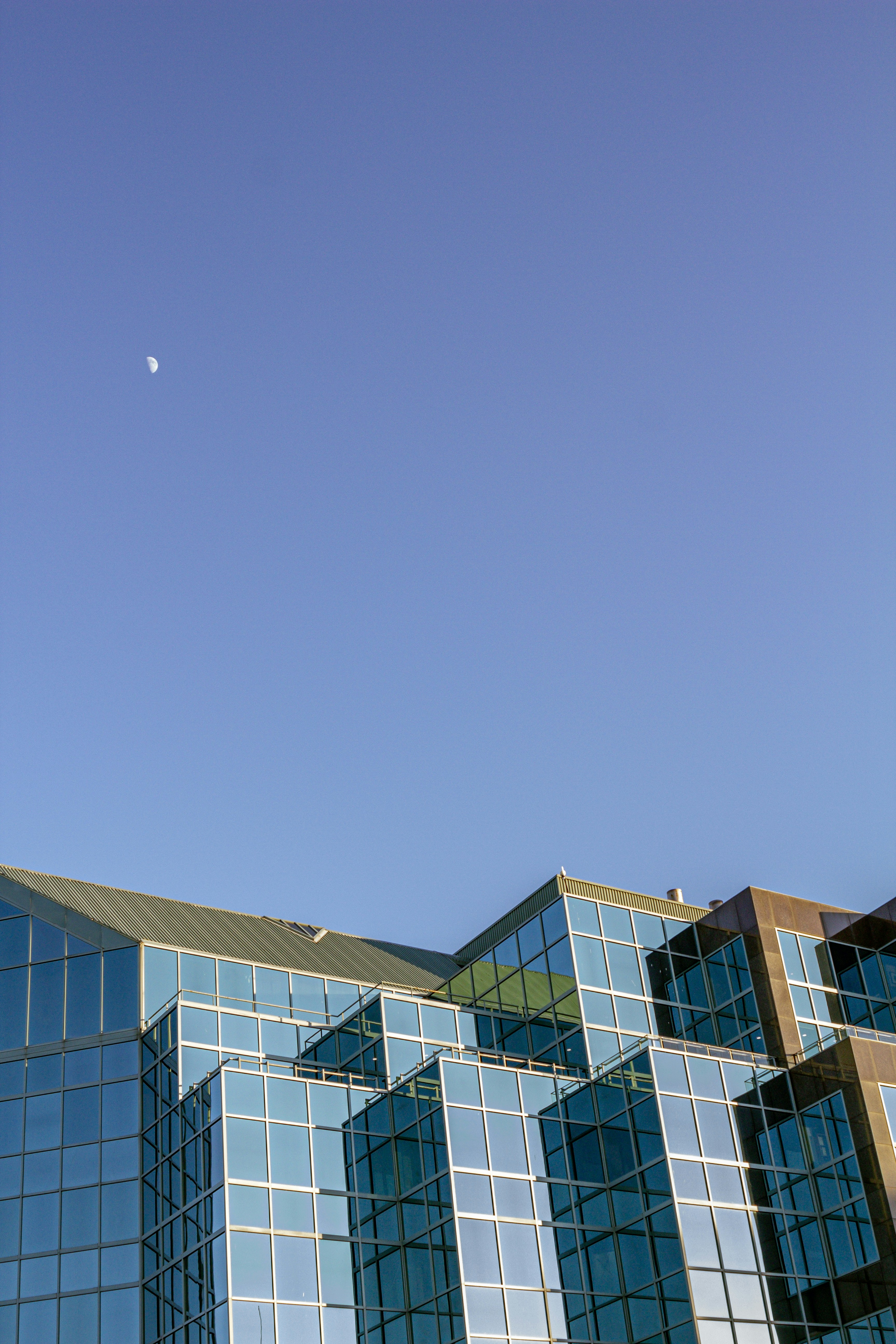 blue and brown concrete building under blue sky during daytime