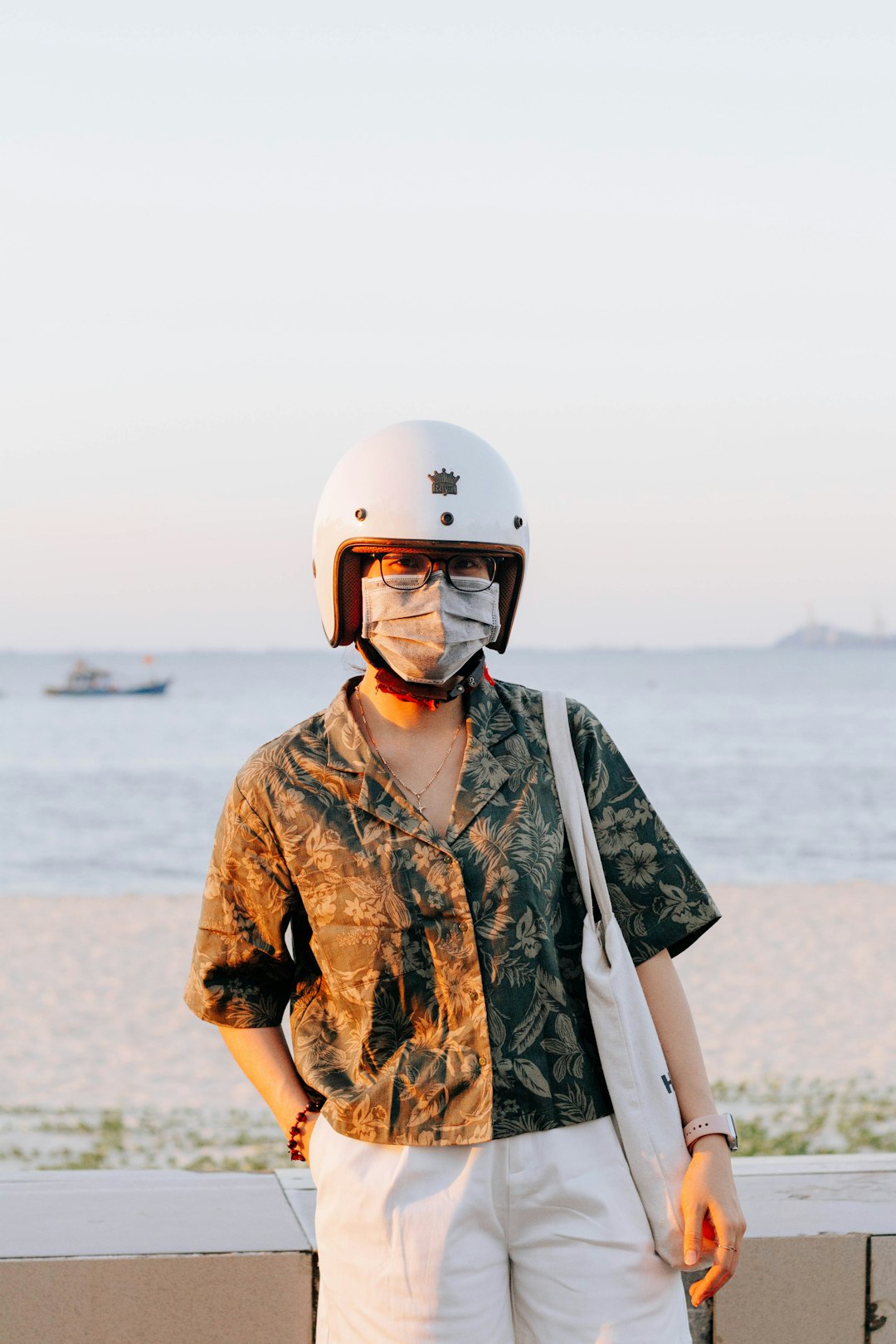 man in brown and green camouflage shirt wearing white helmet standing on beach during daytime