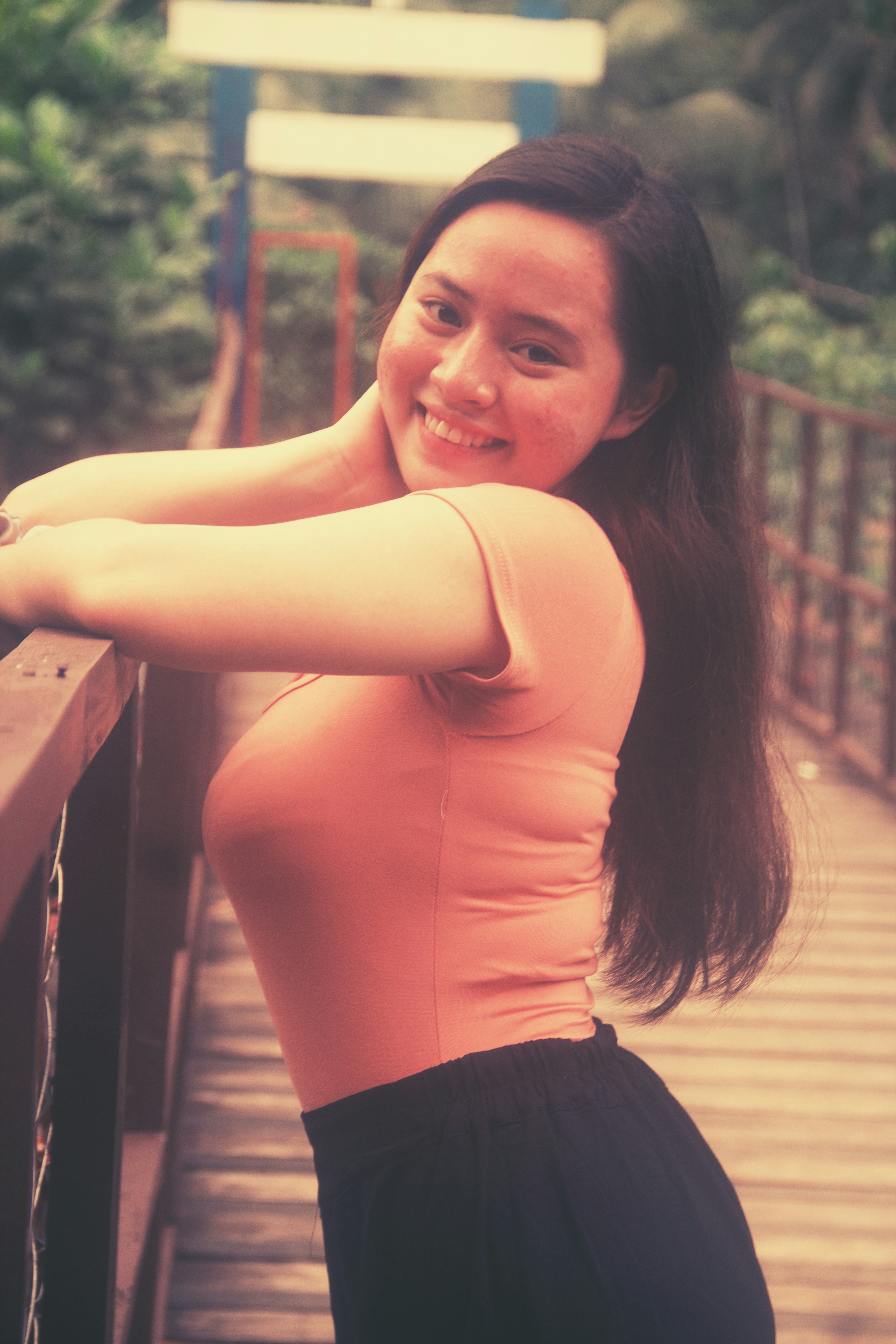 woman in orange tank top and black skirt