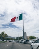 Hand pointing at the Mexico logo on a digital screen
