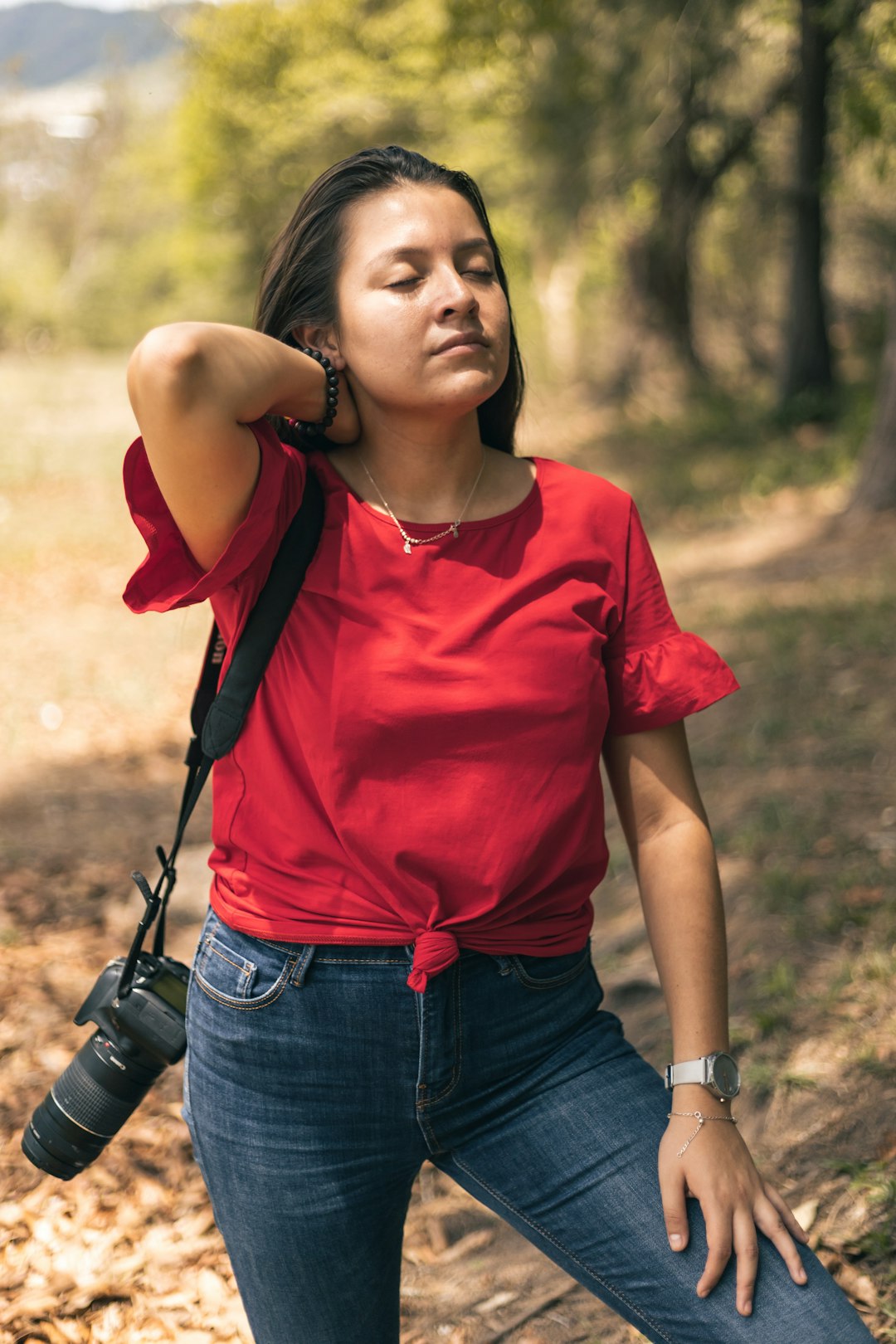 woman in red crew neck t-shirt and blue denim jeans