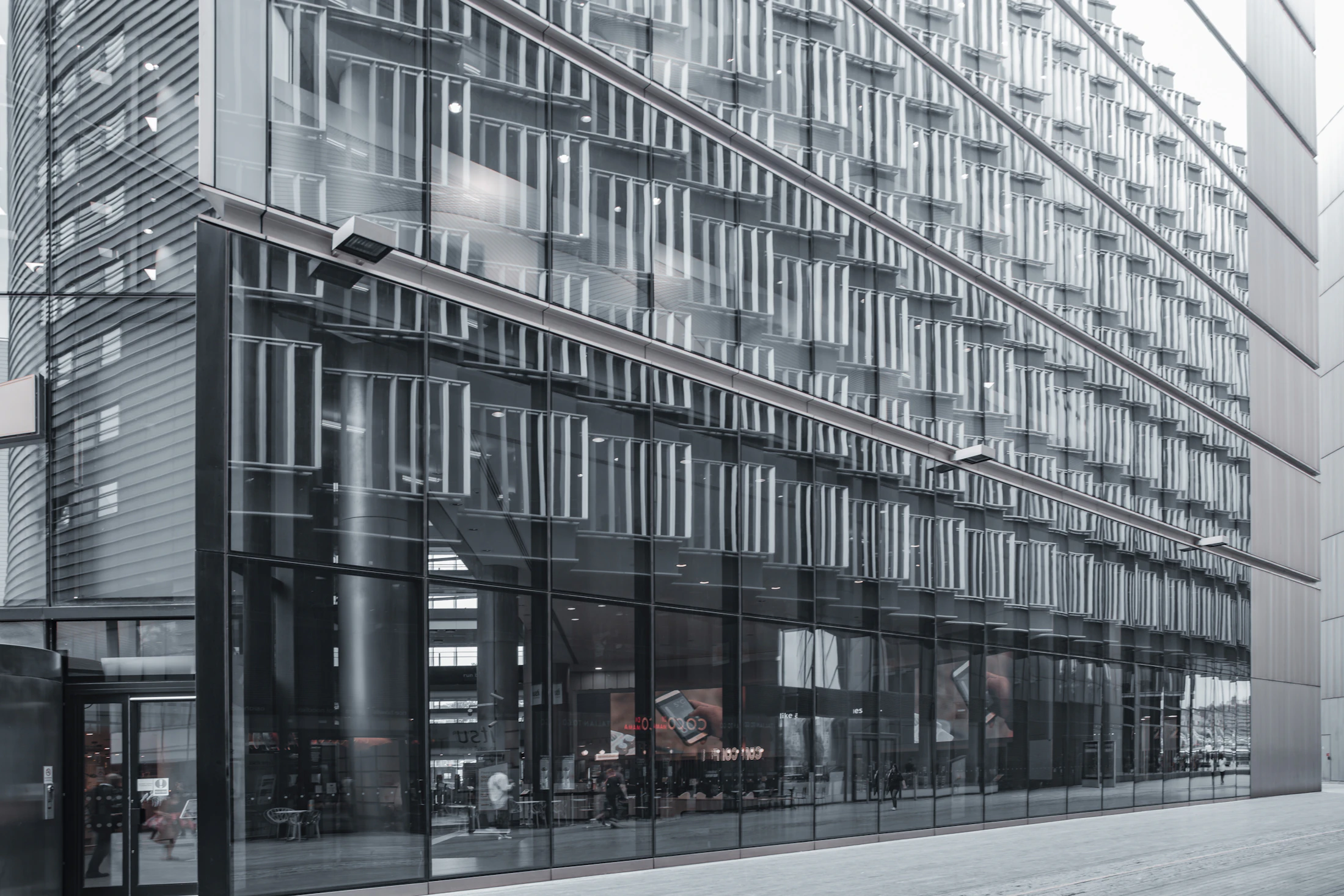 A contemporary glass office tower against the sky