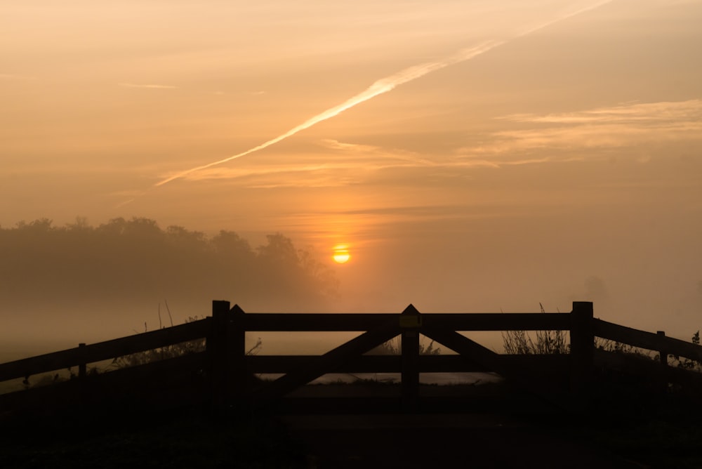 silhouette of wooden fence during sunset