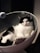 A happy customer showcasing her macramé cat bed.