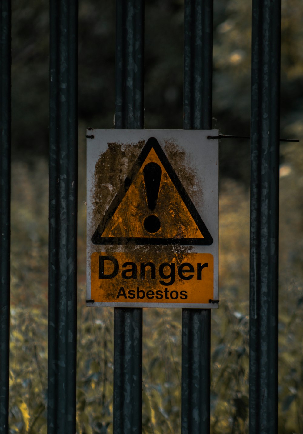 a sign on a metal fence warning of danger