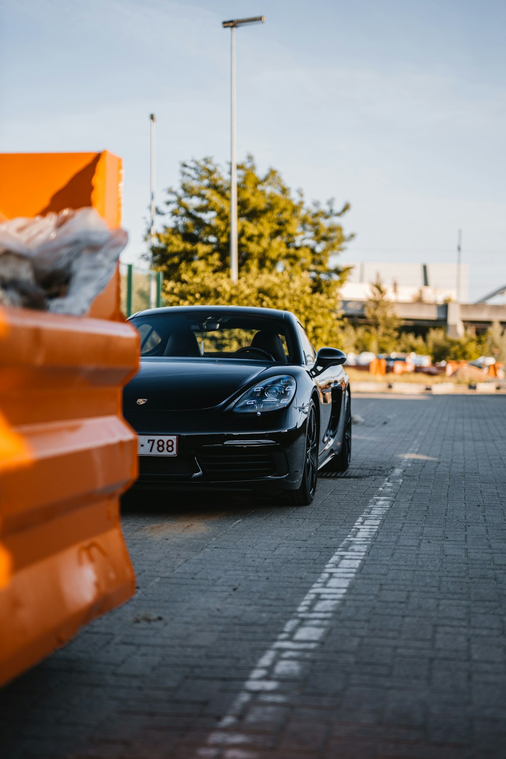 black porsche 911 parked on sidewalk during daytime