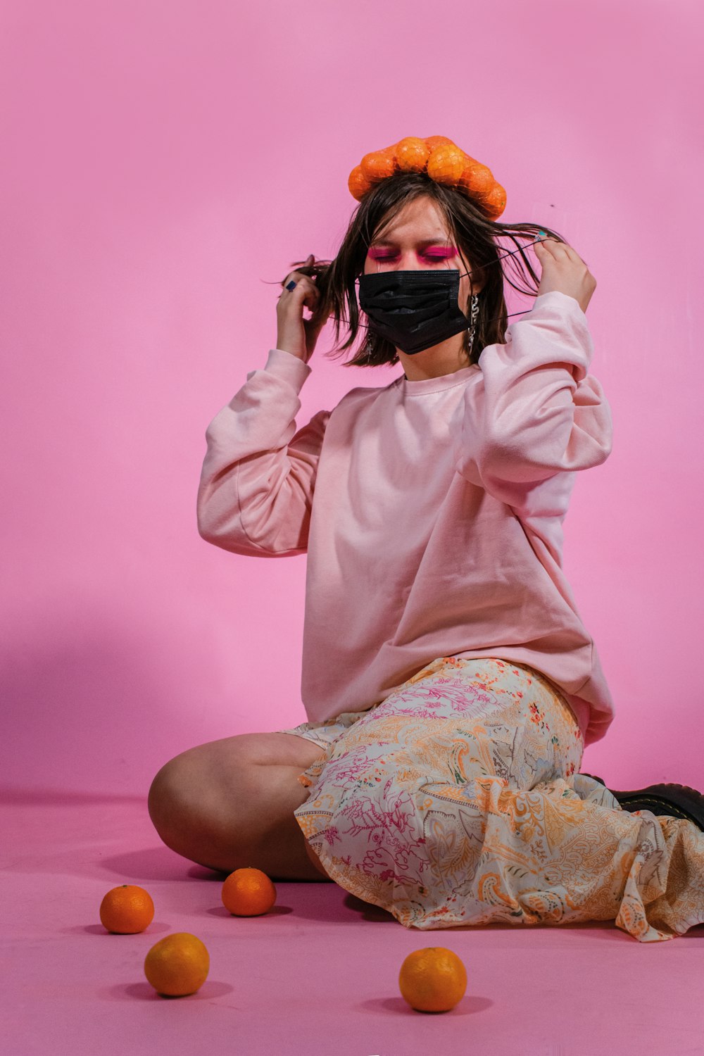 woman in white long sleeve shirt covering her face with her hair