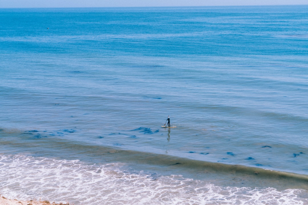 person walking on beach during daytime
