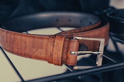 brown leather belt with silver buckle