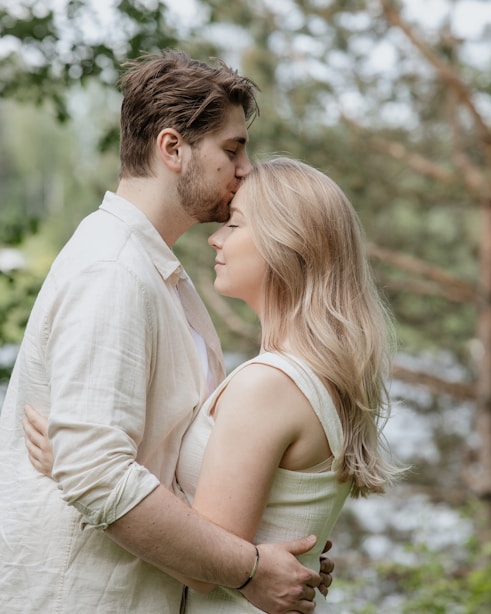 man and woman kissing during daytime