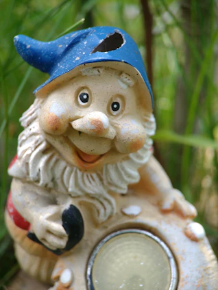 A charming gnome in college colors holding a spirited pennant flag.