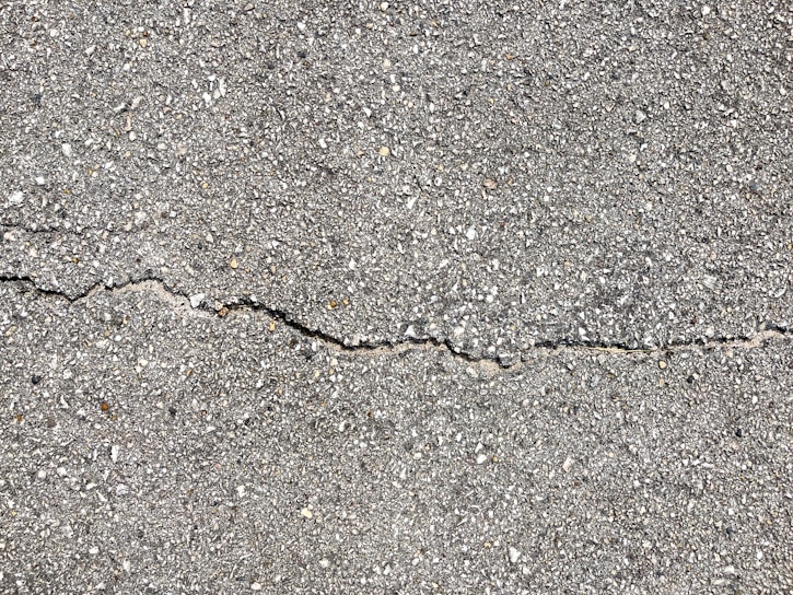 A high-quality photo of freshly poured concrete in a residential driveway.