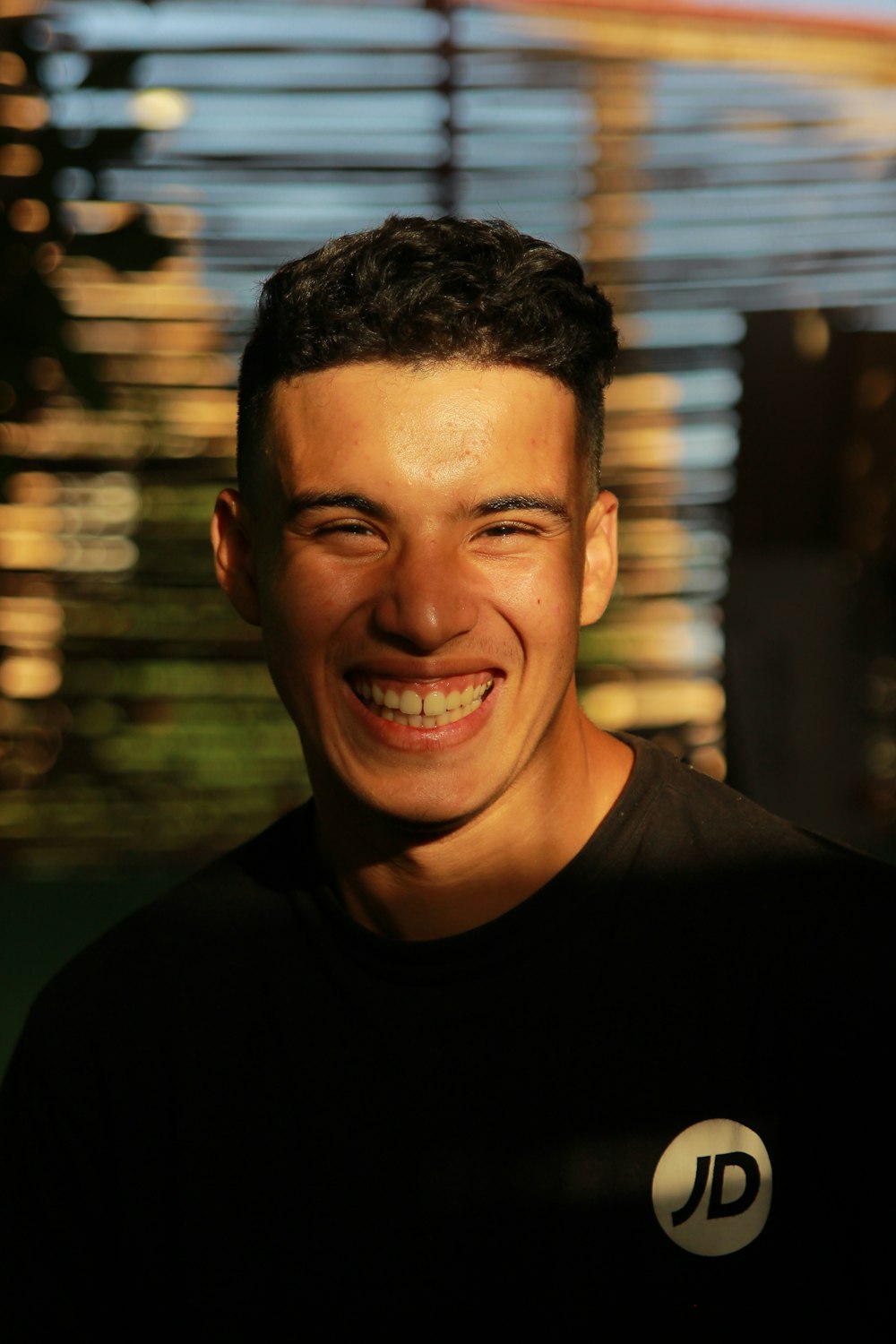 man in black crew neck shirt smiling