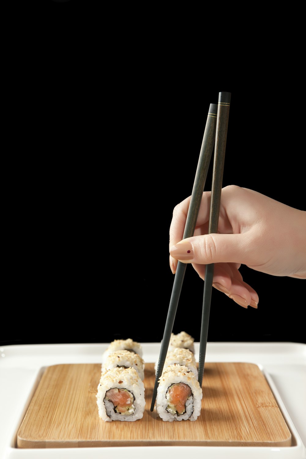 person holding chopsticks and bread