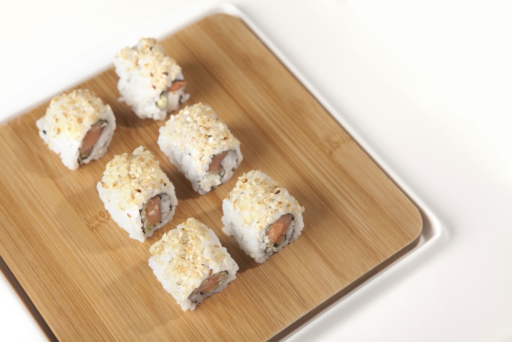 white and brown pastries on brown wooden tray