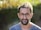 man in blue crew neck shirt wearing black framed eyeglasses