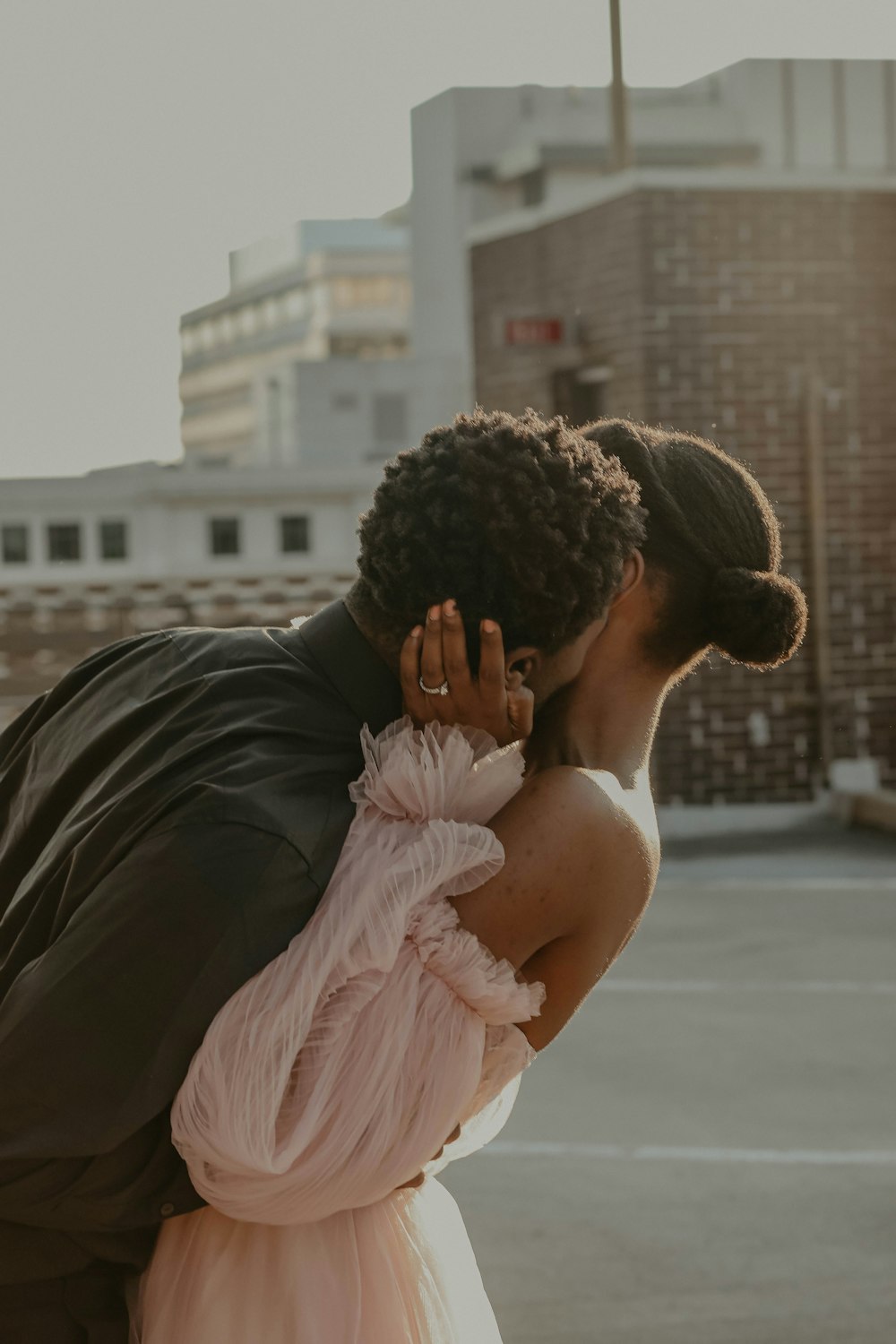 Man In Black Suit Kissing Woman In Pink Dress During Daytime Photo Free Wedding Image On Unsplash