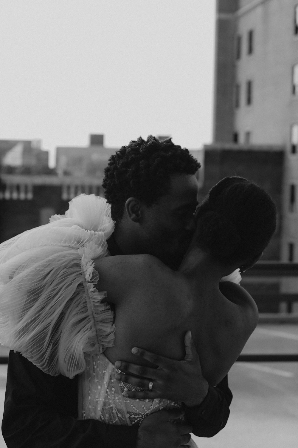 man kissing womans forehead