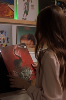 woman in white shirt holding red book
