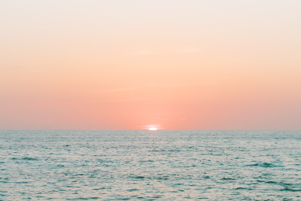 body of water during sunset