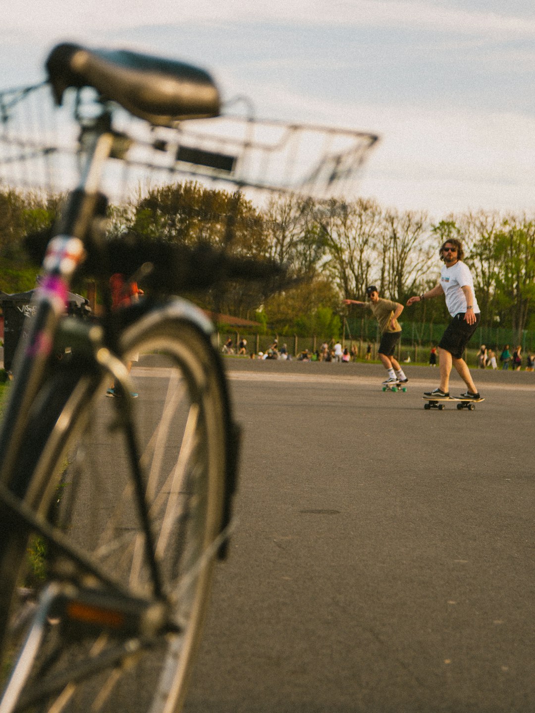 man in white t-shirt and brown shorts riding bicycle on road during daytime