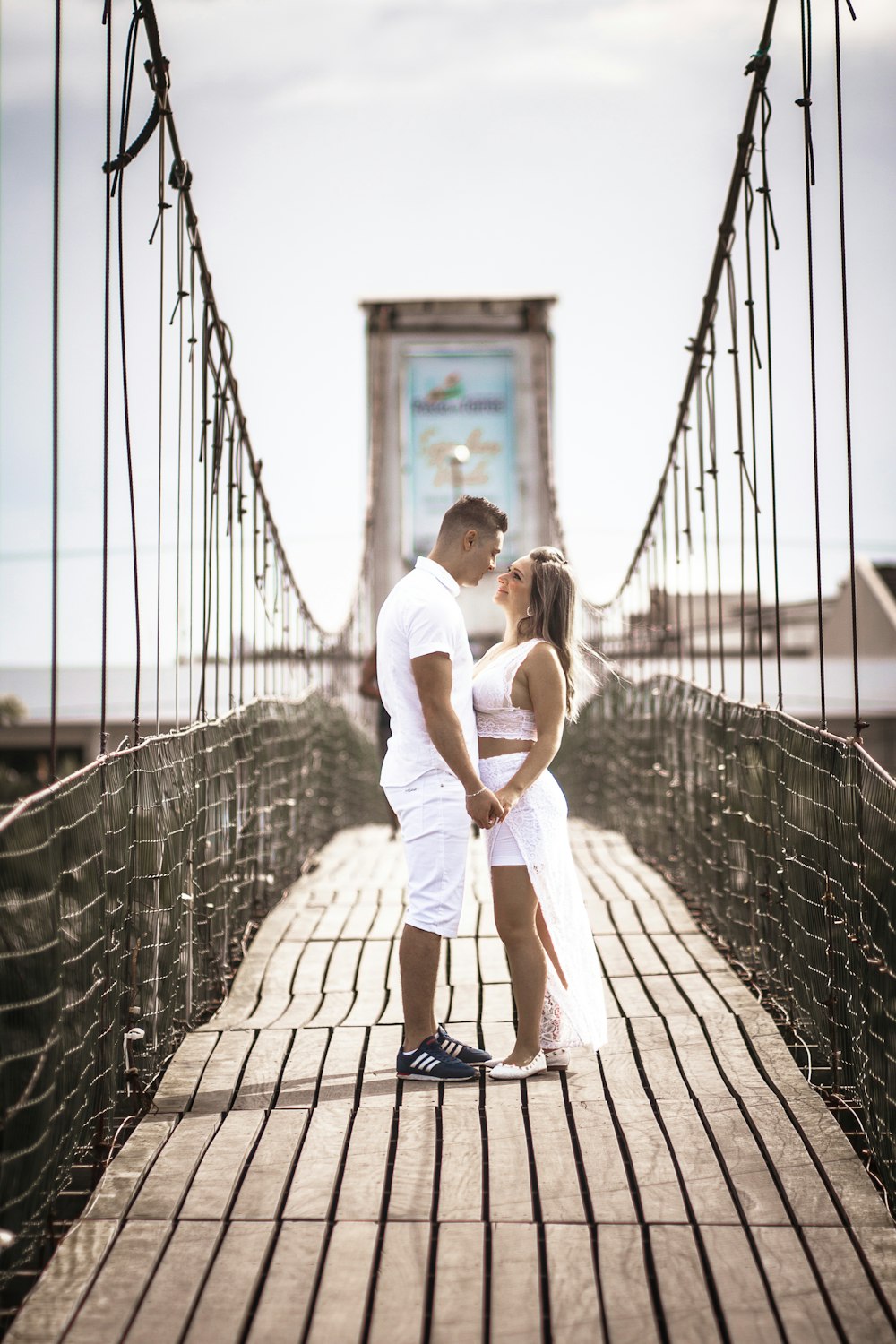 couple walking on bridge during daytime