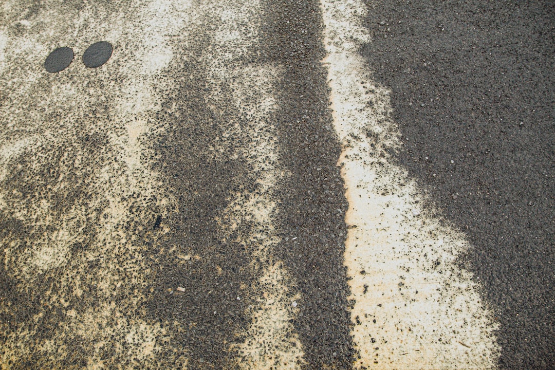 person in black shoes standing on gray concrete floor