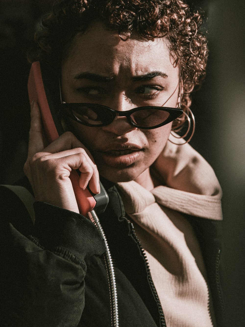 woman in black jacket wearing black sunglasses