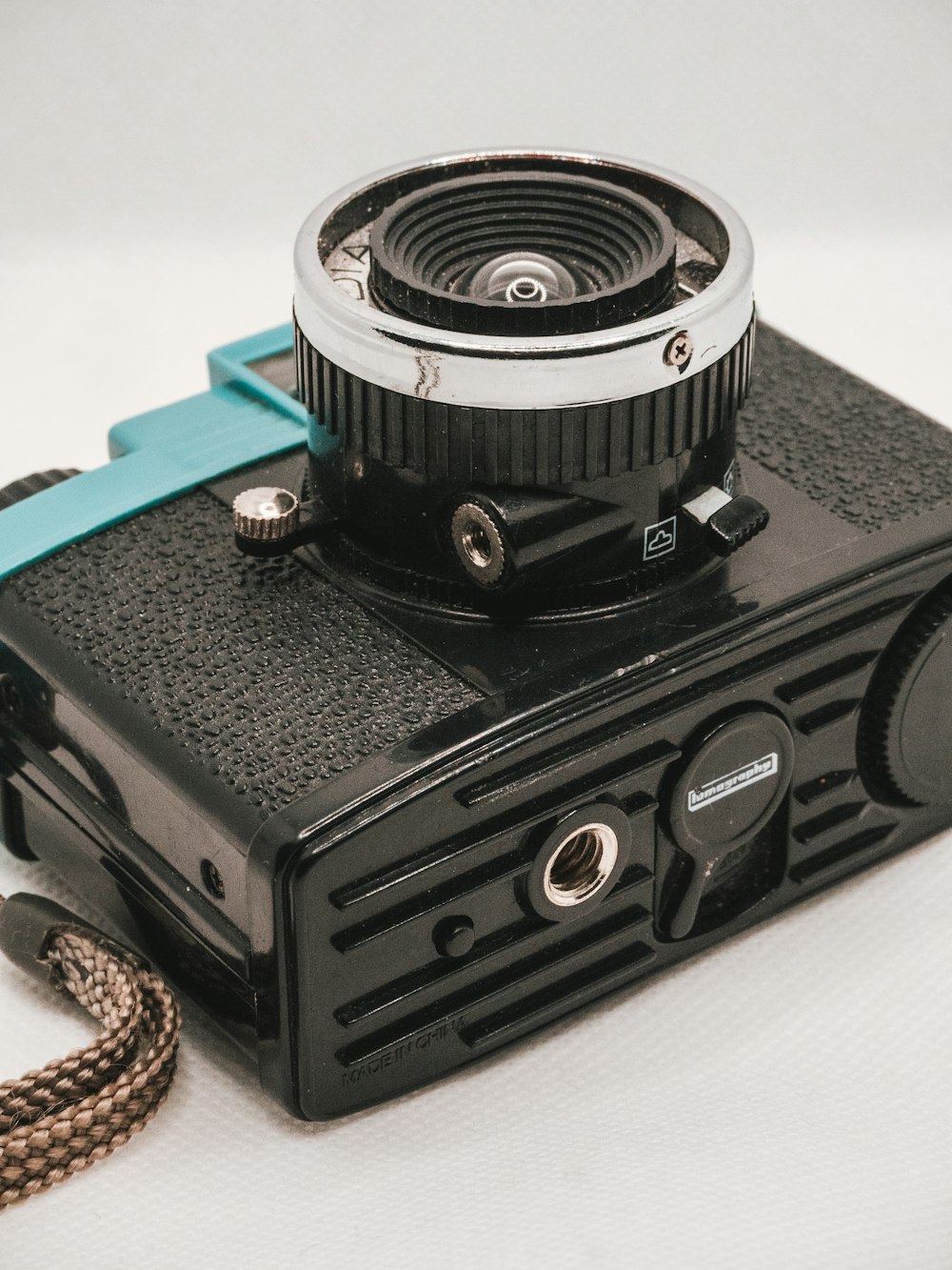 black and silver camera on white table