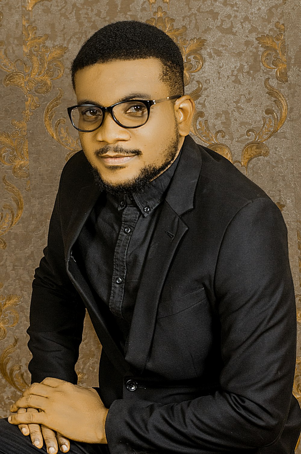 man in black suit jacket wearing black framed eyeglasses