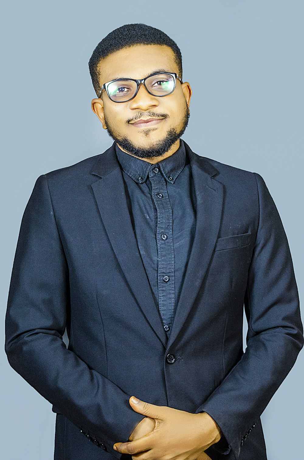 man in black suit jacket wearing sunglasses