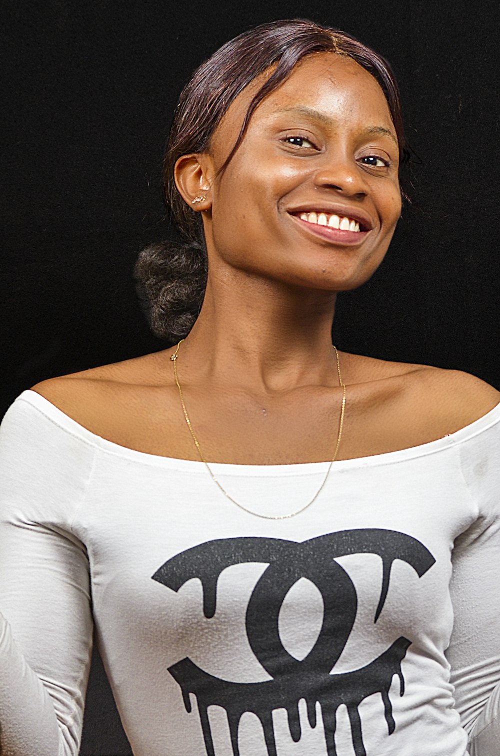 woman in white and black crew neck shirt smiling