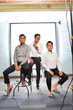 3 women and man sitting on chair