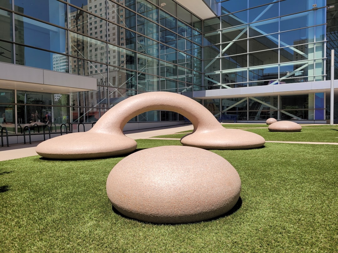 gray concrete spiral statue on green grass field