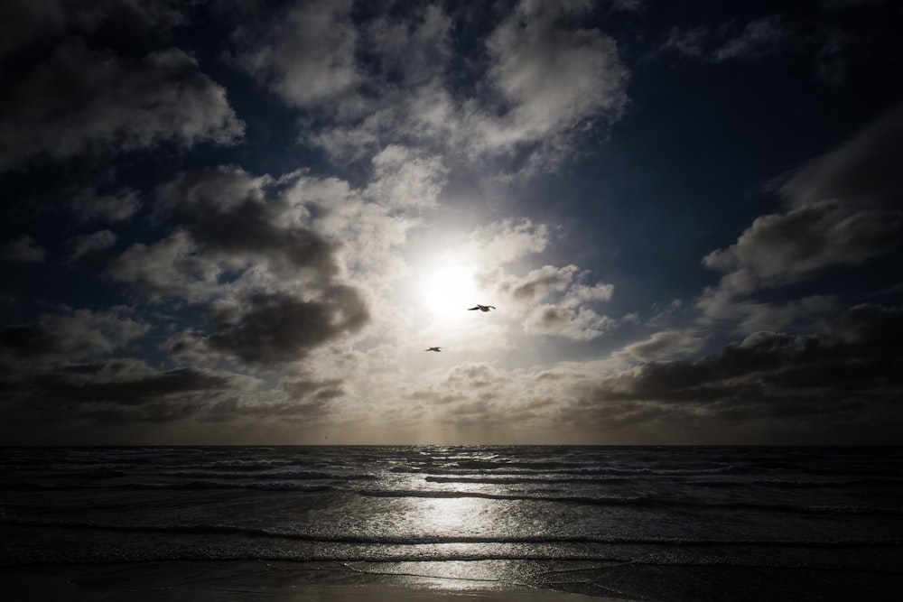 sea under blue and white sky during daytime