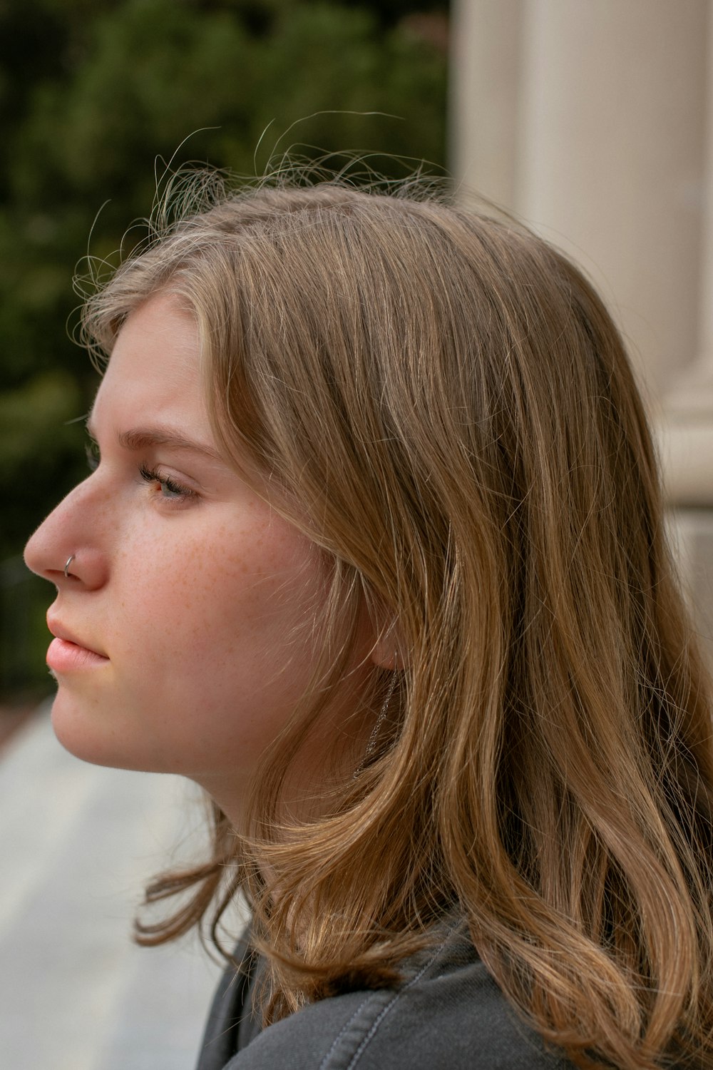 girl in white shirt looking down