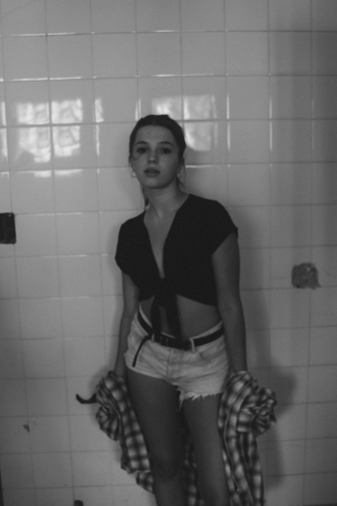 woman in black shirt and white shorts in bathroom